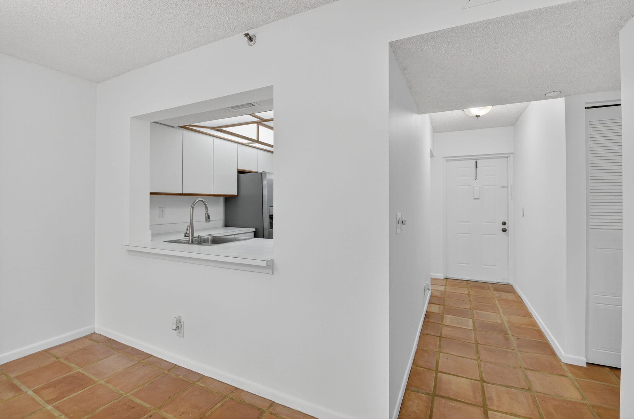 1850 Homewood Boulevard, Unit 214 Delray Beach, FL 33445 - Photo 2 of 38 a hallway with a sink