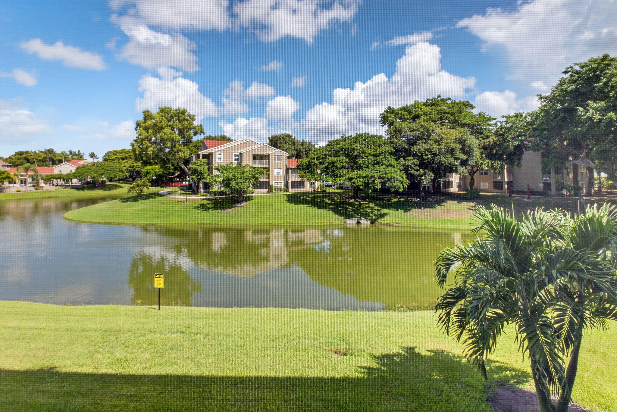 1850 Homewood Boulevard, Unit 214 Delray Beach, FL 33445 - Photo 22 of 38 a view of a lake with a big yard