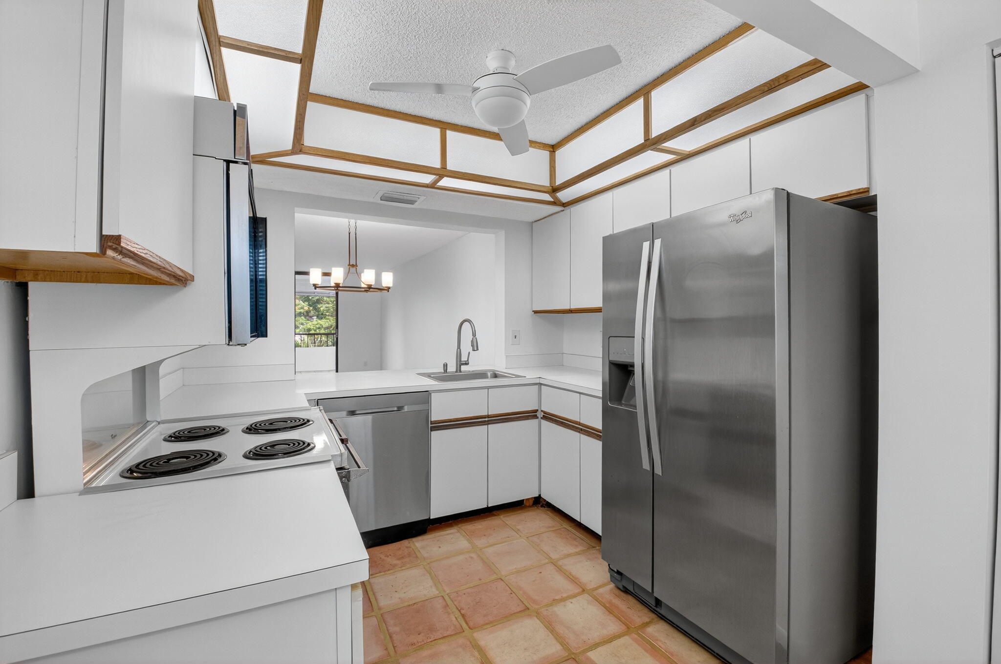 1850 Homewood Boulevard, Unit 214 Delray Beach, FL 33445 - Photo 6 of 38 a kitchen with a refrigerator and a sink