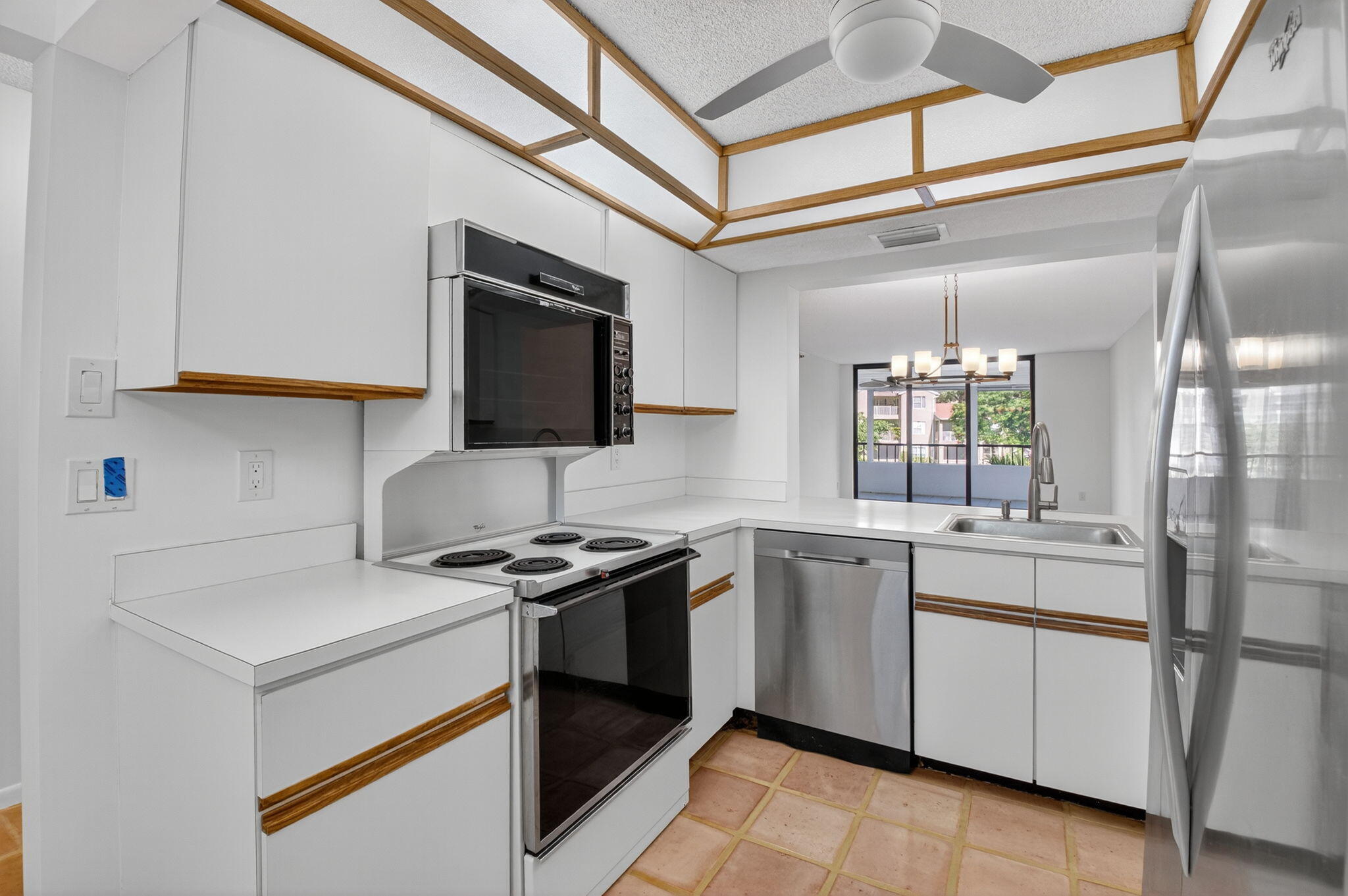 1850 Homewood Boulevard, Unit 214 Delray Beach, FL 33445 - Photo 7 of 38 a kitchen with a sink stove and cabinets