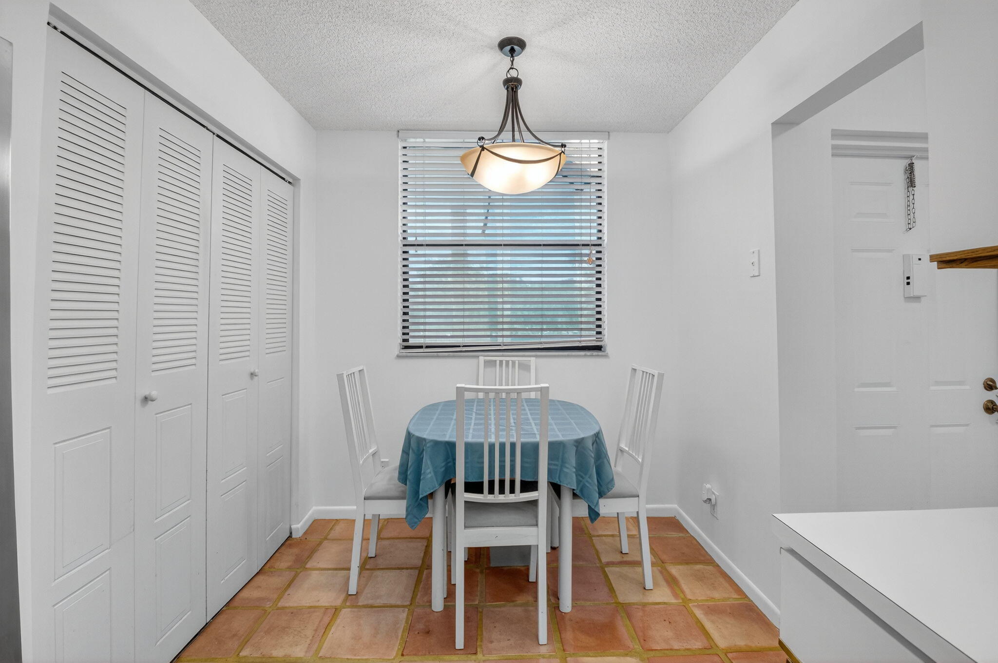 1850 Homewood Boulevard, Unit 214 Delray Beach, FL 33445 - Photo 8 of 38 a dining room with a table and chairs