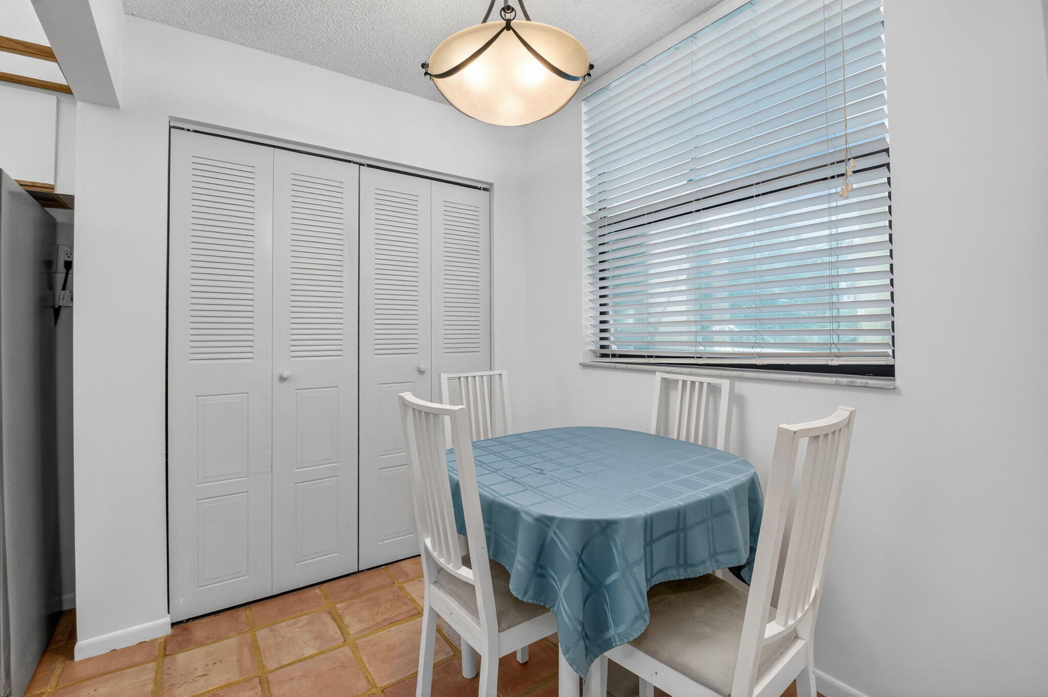 1850 Homewood Boulevard, Unit 214 Delray Beach, FL 33445 - Photo 9 of 38 a view of a dining room with furniture and a chandelier