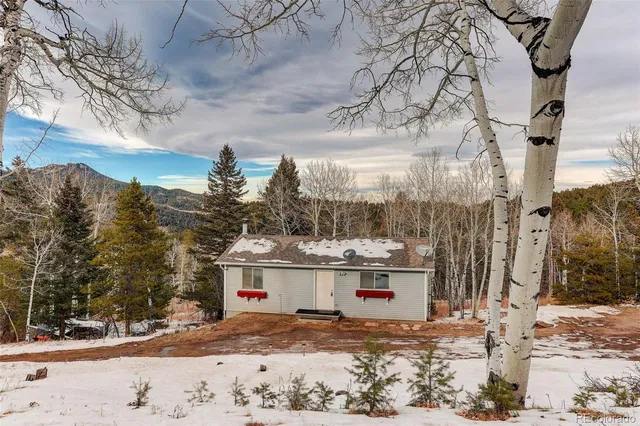 a view of residential house with a yard and covered with snow