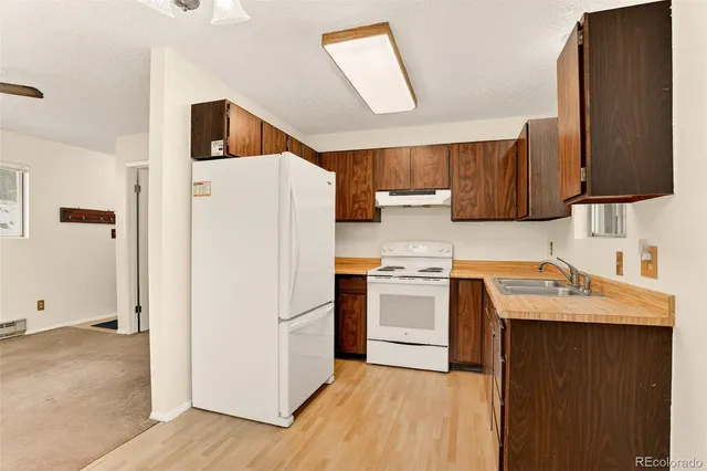 a kitchen with a refrigerator sink and stove
