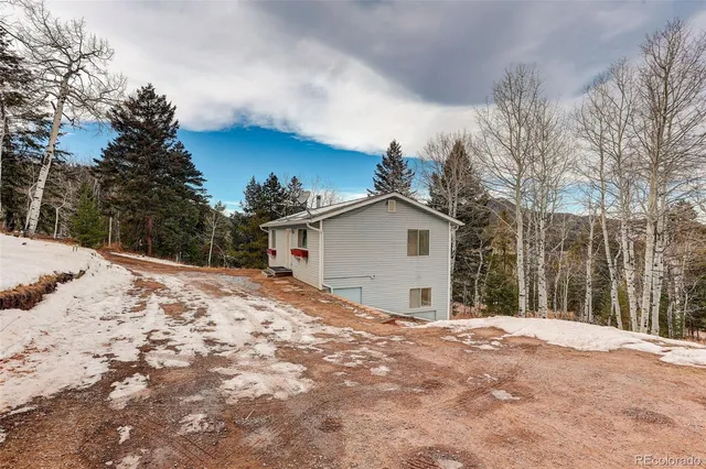 a view of a house with a yard covered in snow