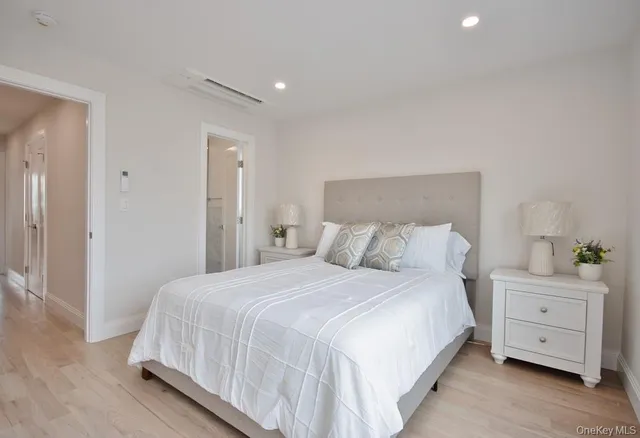 a bedroom with a bed and a night stand