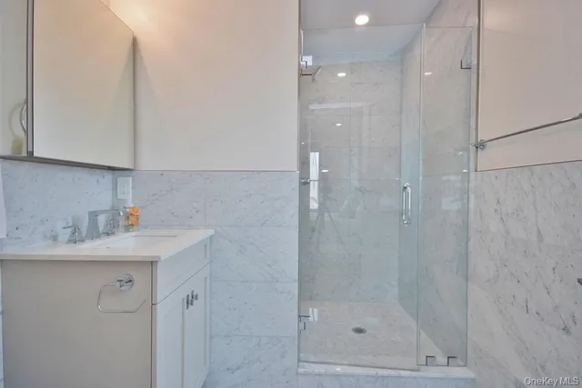 a bathroom with a shower toilet and sink