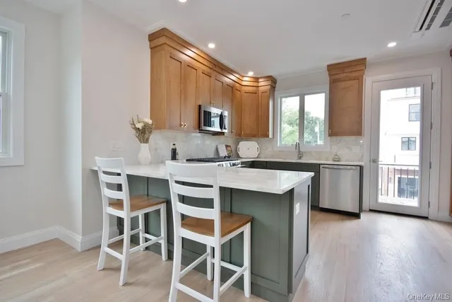 a kitchen with a sink cabinets and window