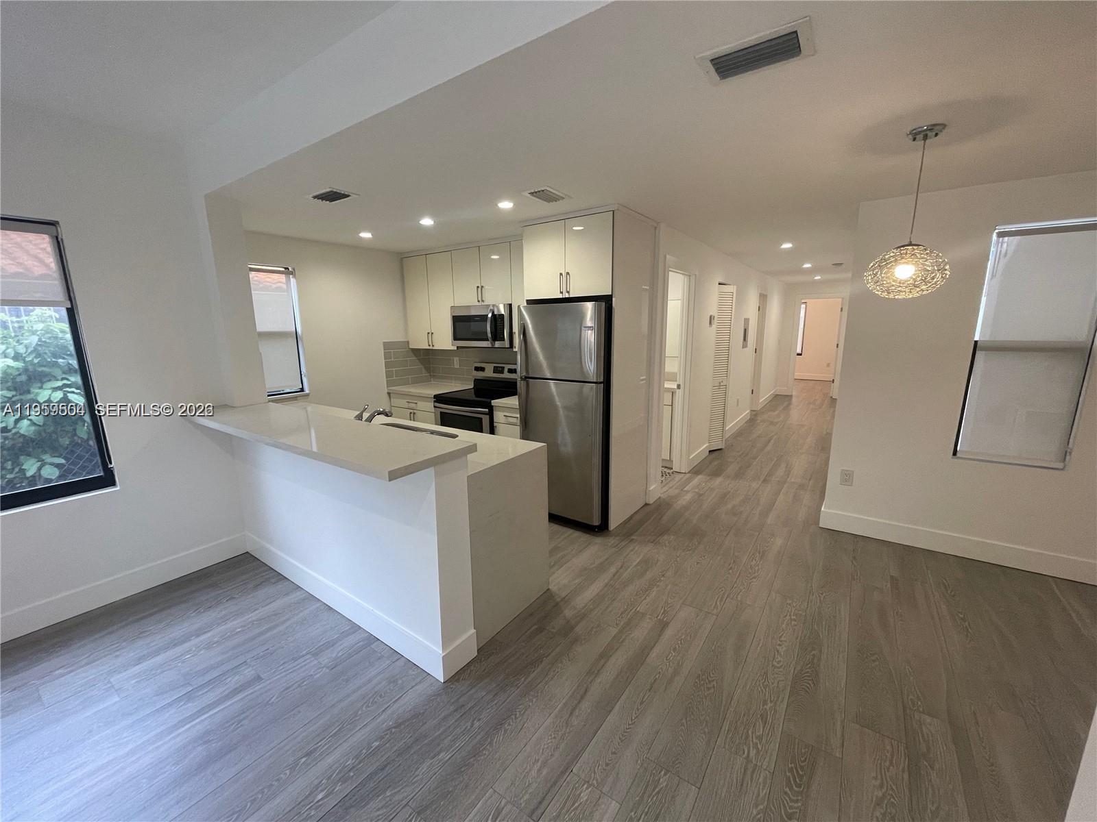 1637 Southwest 10th Street, Unit 2 Miami, FL 33135 - Photo 1 of 9 a kitchen with a refrigerator and a sink