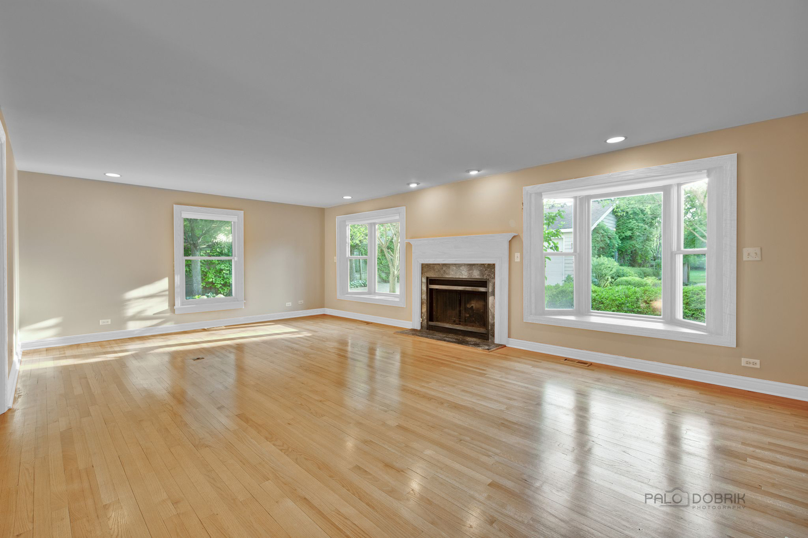 204 Wildwood Road Lake Forest, IL 60045 - Photo 6 of 29 an empty room with wooden floor fireplace and windows
