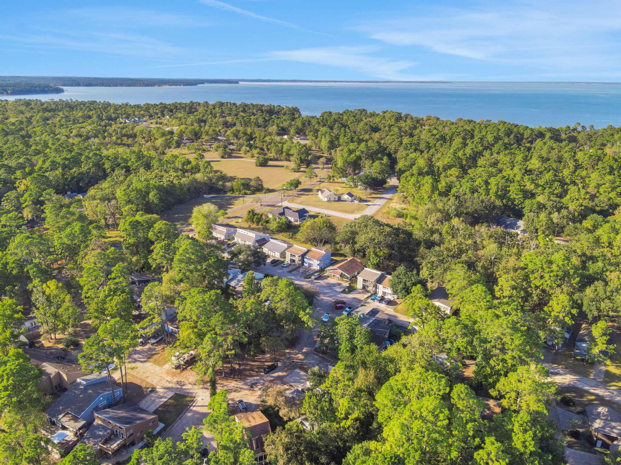 90 Harbour Lane Coldspring, TX 77331 - Photo 25 of 40 Aerial view showing the home’s proximity to Lake Livingston and the surrounding wooded neighborhood.