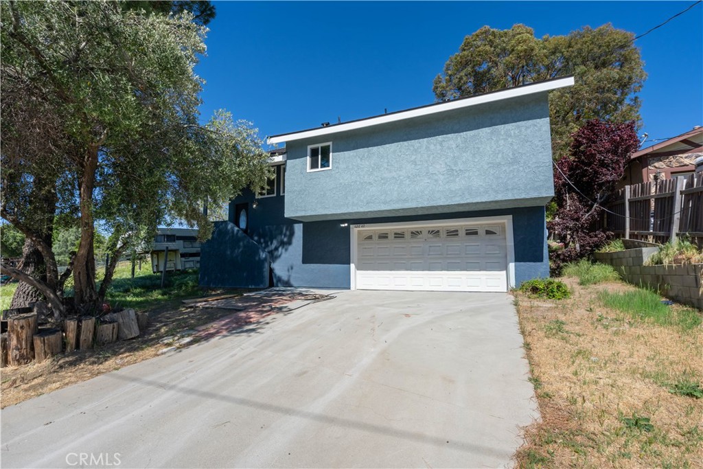 42640 Ranch Club Road Lake Hughes, CA 93532 - Photo 22 of 27 a front view of a house with a yard and garage