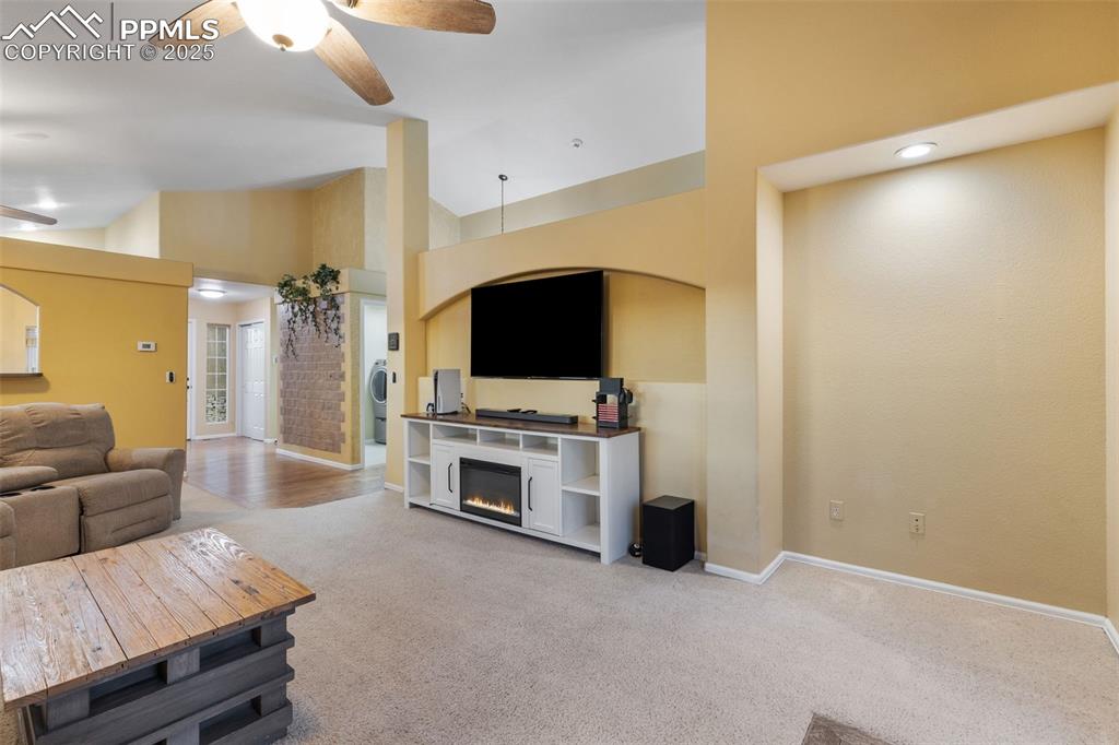 9015 Oakmont Road Peyton, CO 80831 - Photo 15 of 44 a living room with furniture and a flat screen tv