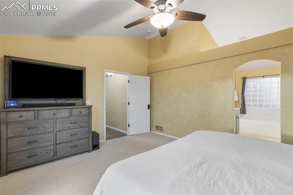 9015 Oakmont Road Peyton, CO 80831 - Photo 17 of 44 a bedroom with a bed and a flat screen tv