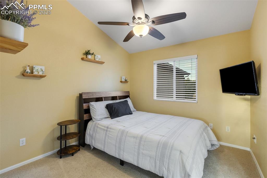 9015 Oakmont Road Peyton, CO 80831 - Photo 24 of 44 a bedroom with a bed tv and a window