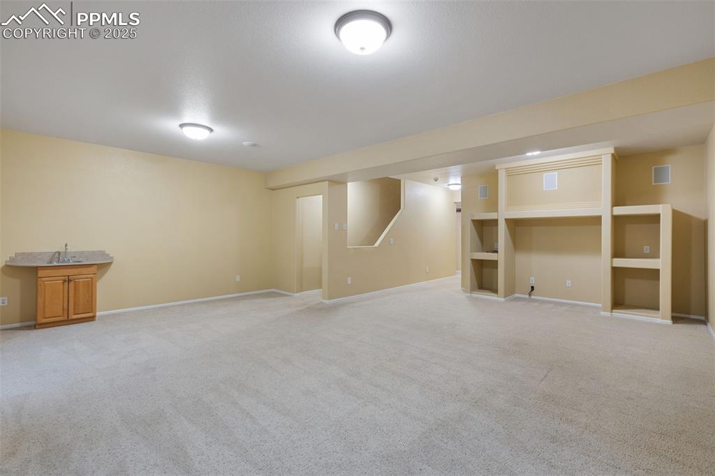 9015 Oakmont Road Peyton, CO 80831 - Photo 25 of 44 a view of an empty room with a cabinet and mirrors