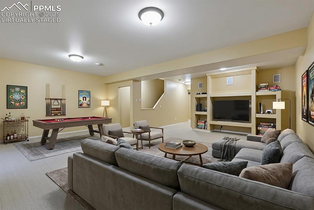 9015 Oakmont Road Peyton, CO 80831 - Photo 26 of 44 a living room with furniture and a flat screen tv