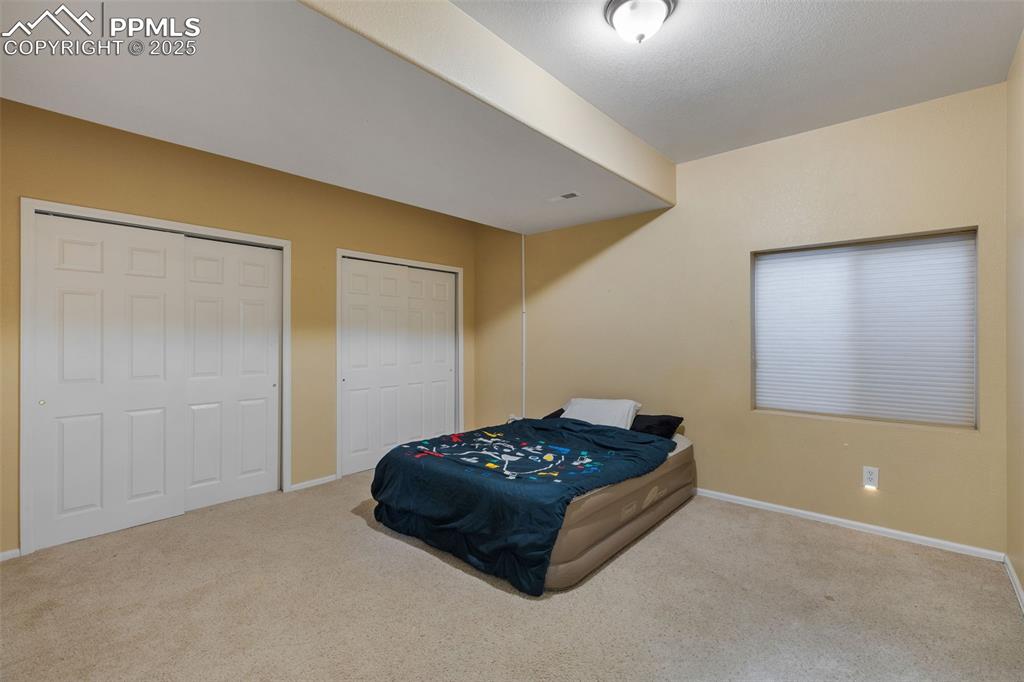9015 Oakmont Road Peyton, CO 80831 - Photo 31 of 44 a room with a bed and a window