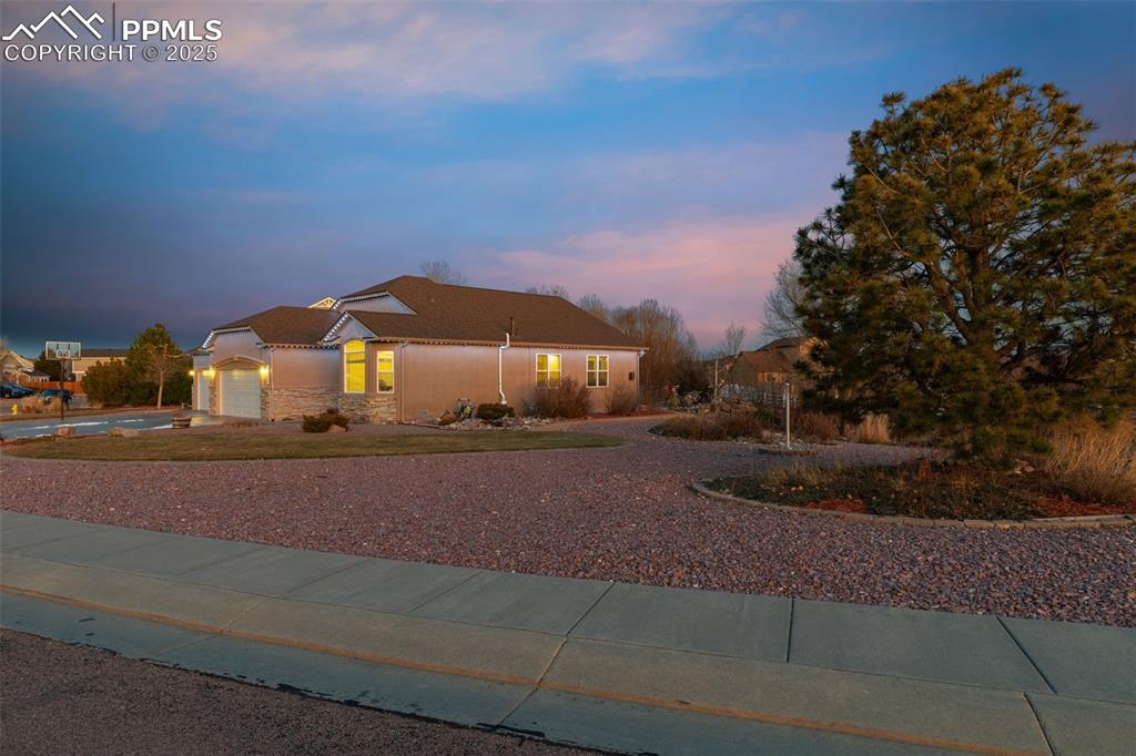 9015 Oakmont Road Peyton, CO 80831 - Photo 32 of 44 a front view of a house with a yard and garage