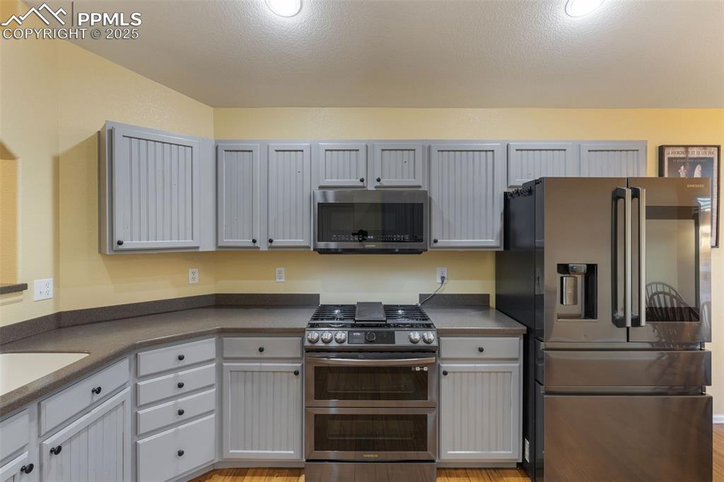 9015 Oakmont Road Peyton, CO 80831 - Photo 7 of 44 a kitchen with granite countertop a stove a refrigerator and a sink
