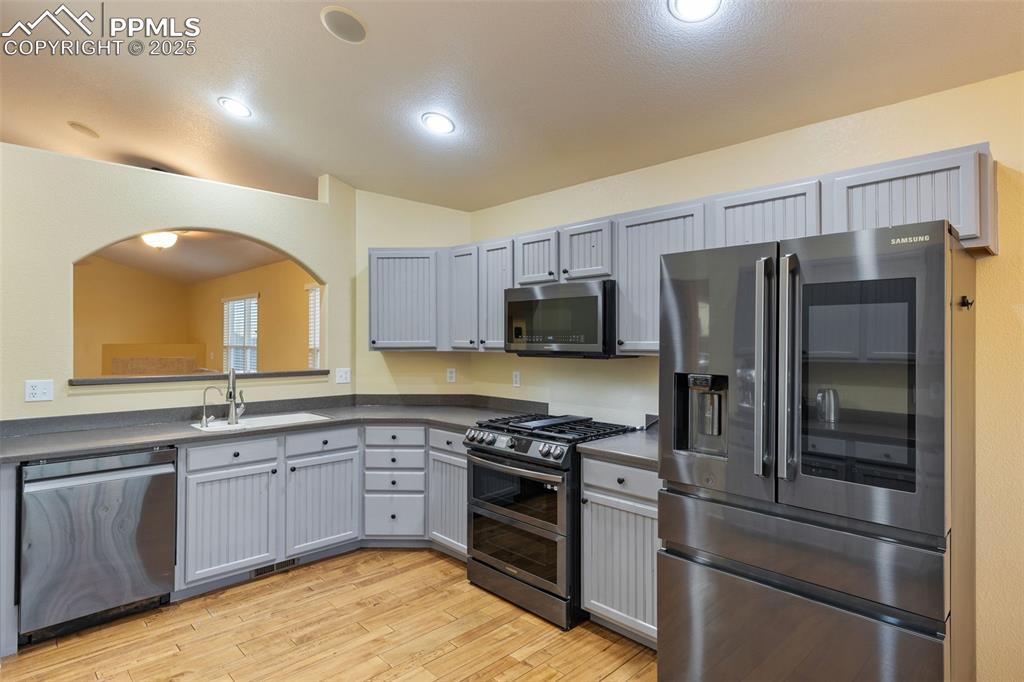 9015 Oakmont Road Peyton, CO 80831 - Photo 8 of 44 a kitchen with a sink stainless steel appliances and cabinets