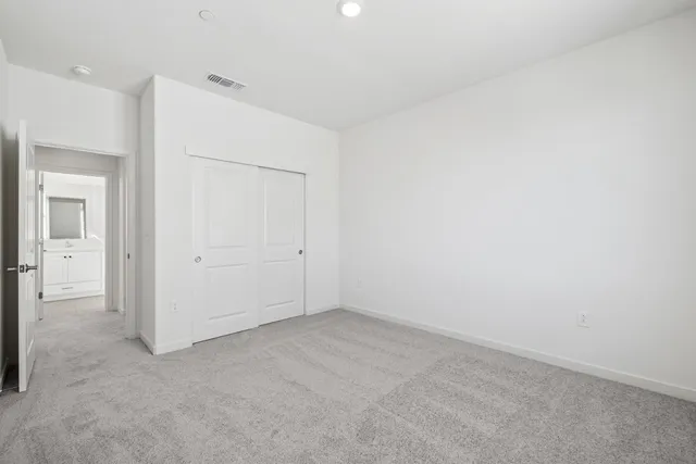 an empty room with closet area