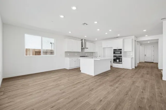 a view of kitchen with wooden floor and window