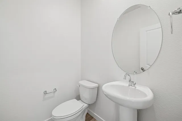 a bathroom with a sink a mirror and a toilet
