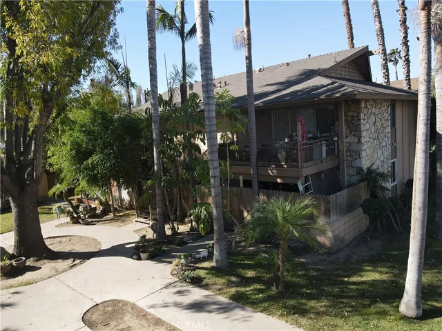 a view of a house with a yard and sitting area
