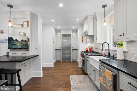 a kitchen with stainless steel appliances a stove a sink and a refrigerator