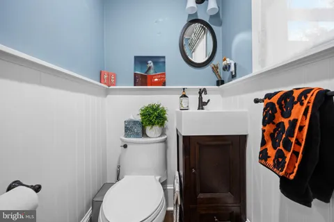 a view of a hallway with wooden floor and stairs