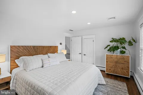 a bedroom with a large bed and a window