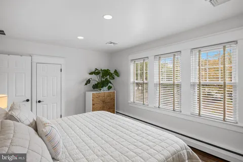 a bedroom with a bed chair and a window
