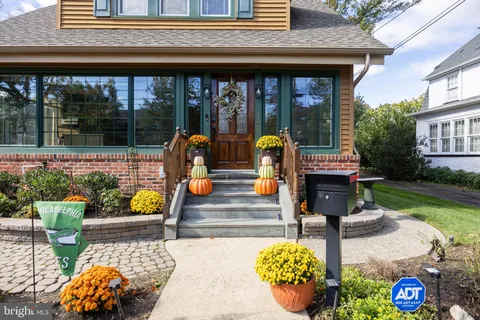 a front view of a house with outdoor seating