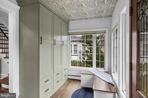 a living room with furniture cabinets and a rug