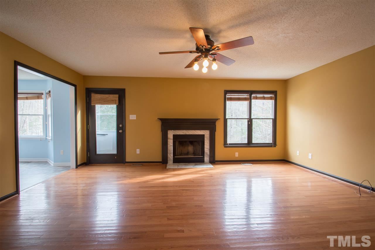 500 Jordan Ridge Lane Raleigh, NC 27603 - Photo 3 of 12 a view of an empty room with a window and fireplace