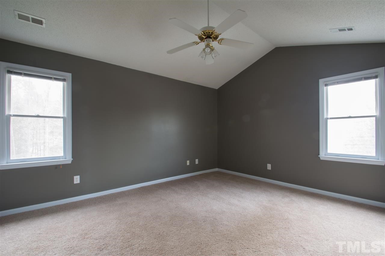 500 Jordan Ridge Lane Raleigh, NC 27603 - Photo 10 of 12 an empty room with a window and a fan