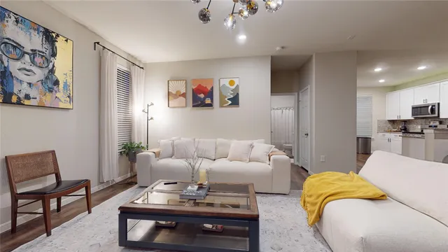 a living room with furniture and kitchen view