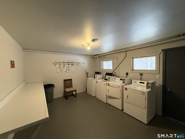 a room with white cabinets and white appliances