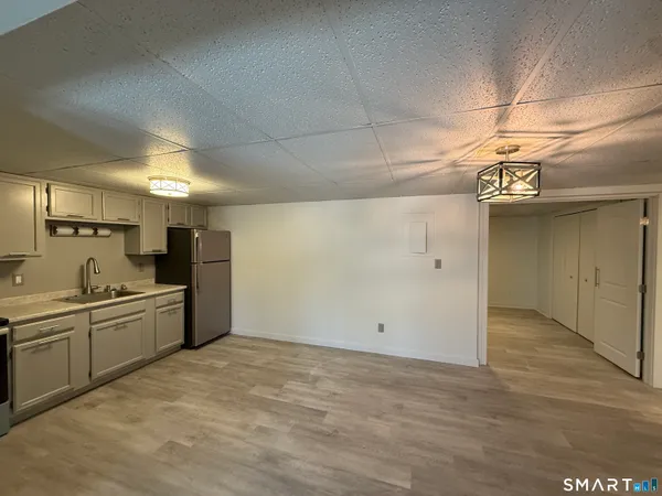 a kitchen with stainless steel appliances a sink and cabinets