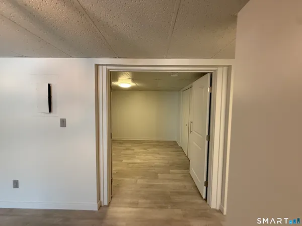 a view of a hallway with wooden floor