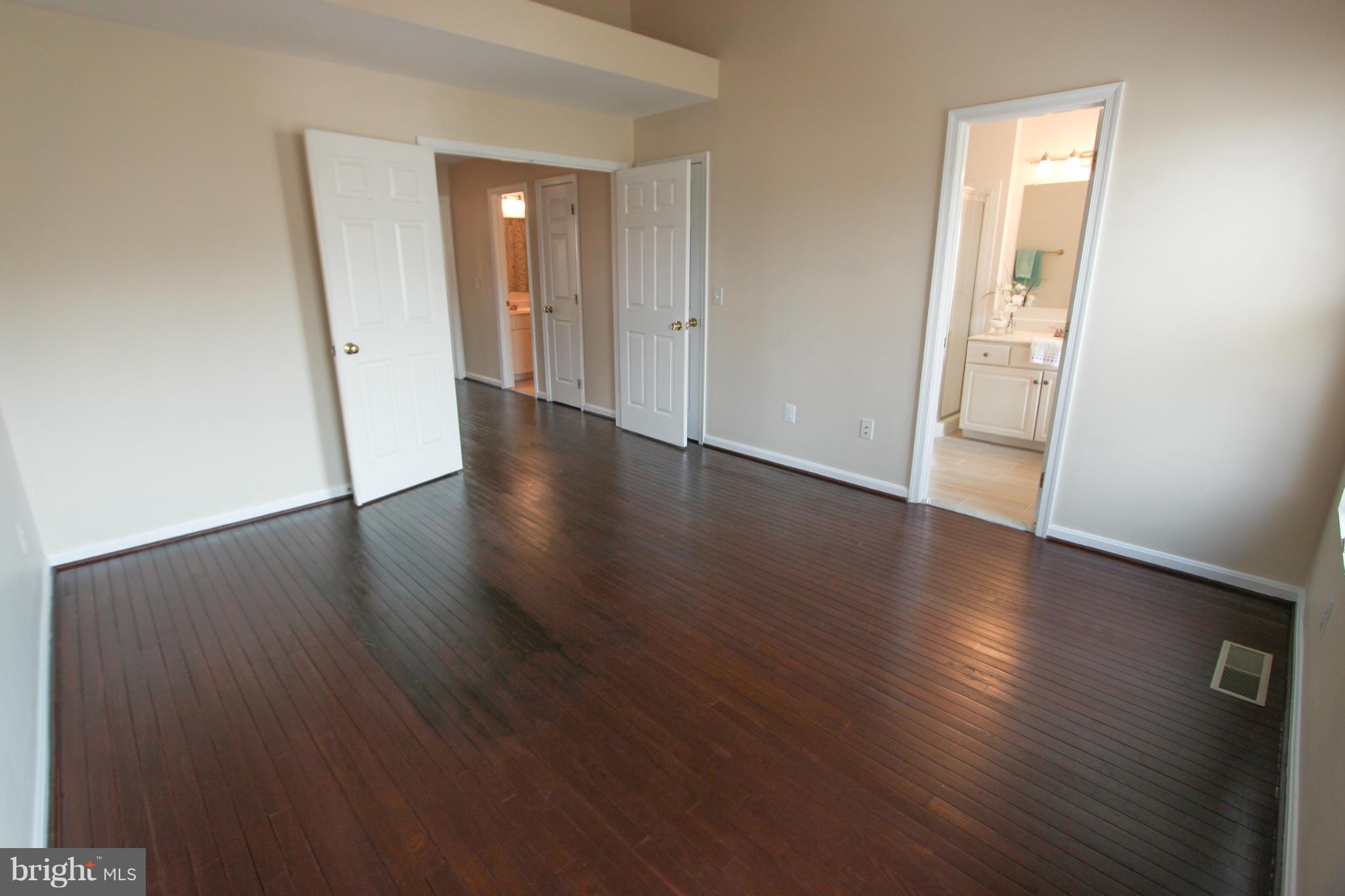 1706 Random Stone Court Reston, VA 20190 - Photo 13 of 30 an empty room with wooden floor and windows