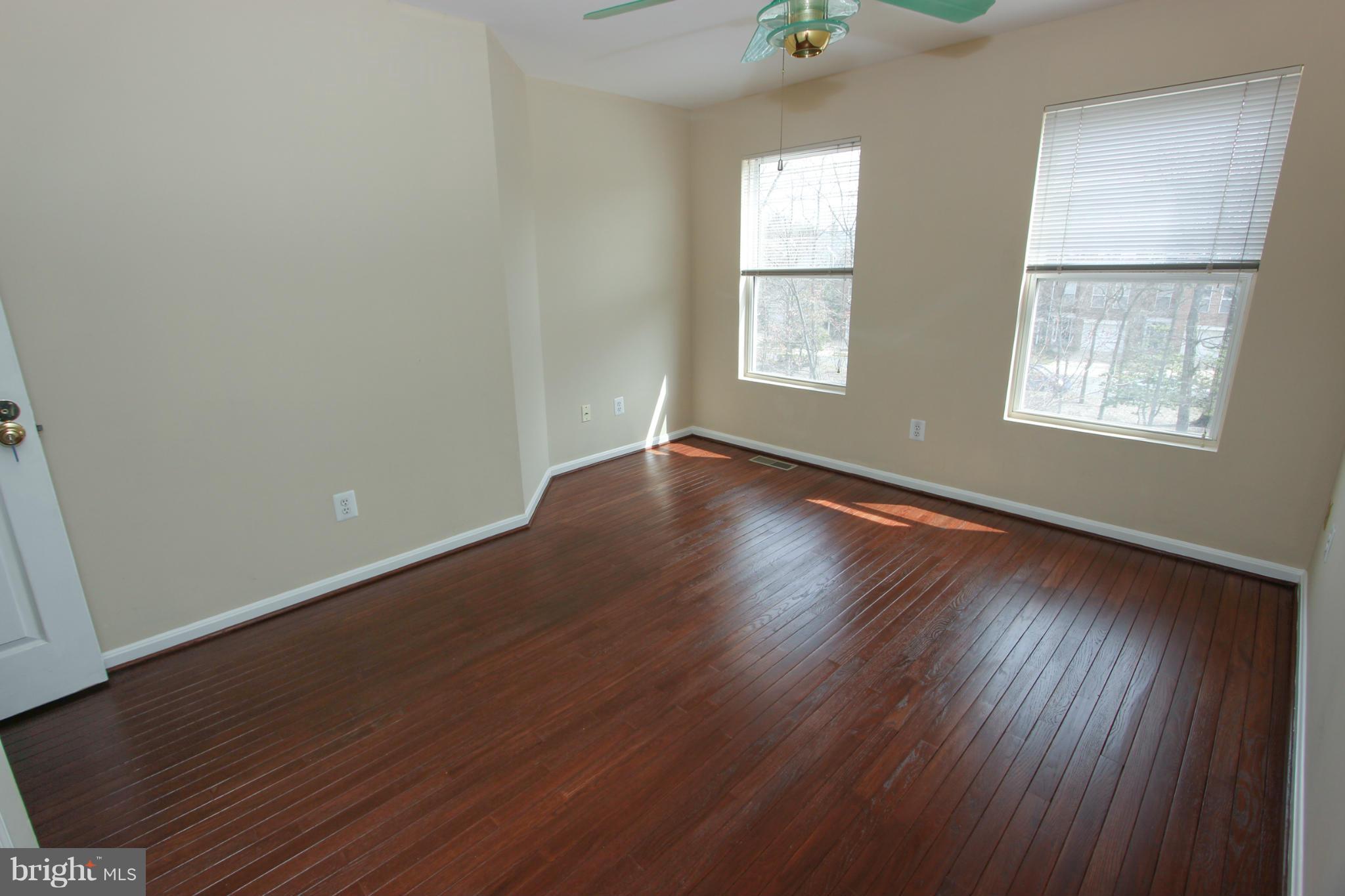 1706 Random Stone Court Reston, VA 20190 - Photo 15 of 30 an empty room with wooden floor and windows
