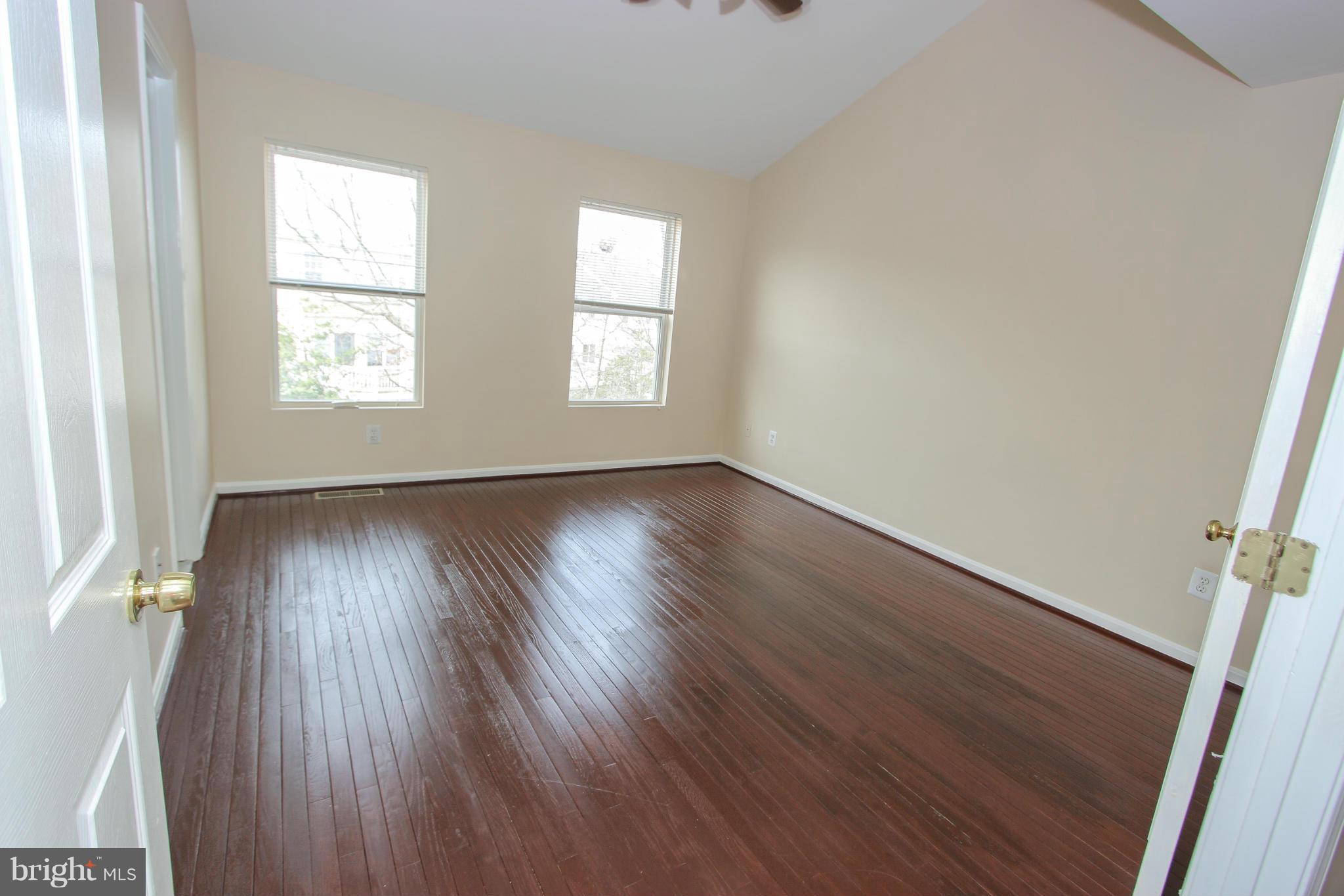 1706 Random Stone Court Reston, VA 20190 - Photo 16 of 30 an empty room with wooden floor and windows