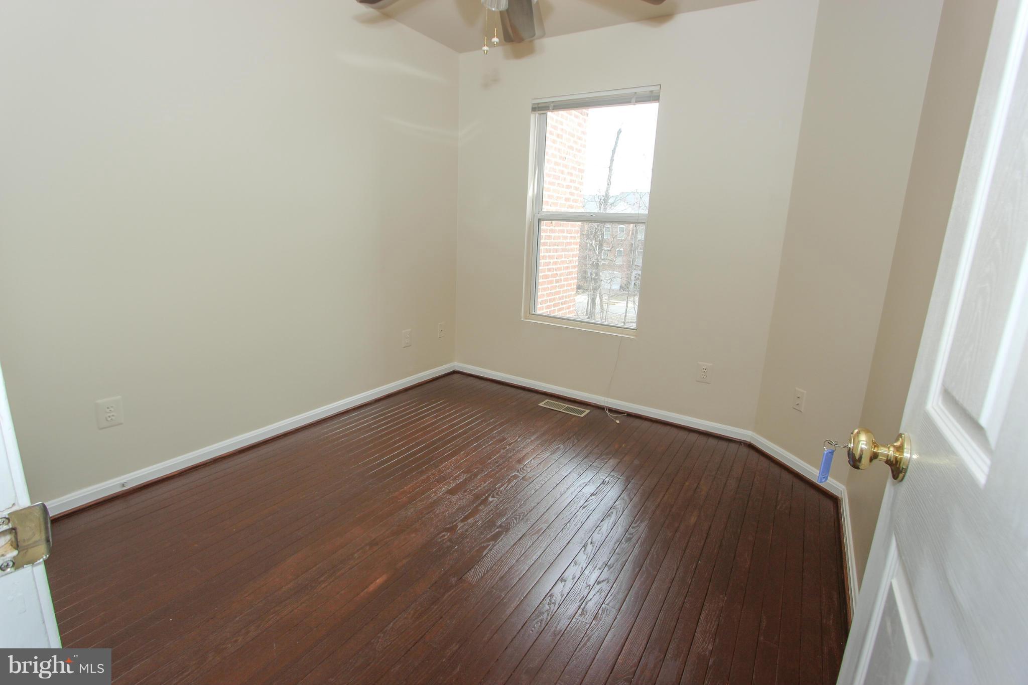 1706 Random Stone Court Reston, VA 20190 - Photo 17 of 30 an empty room with wooden floor and windows