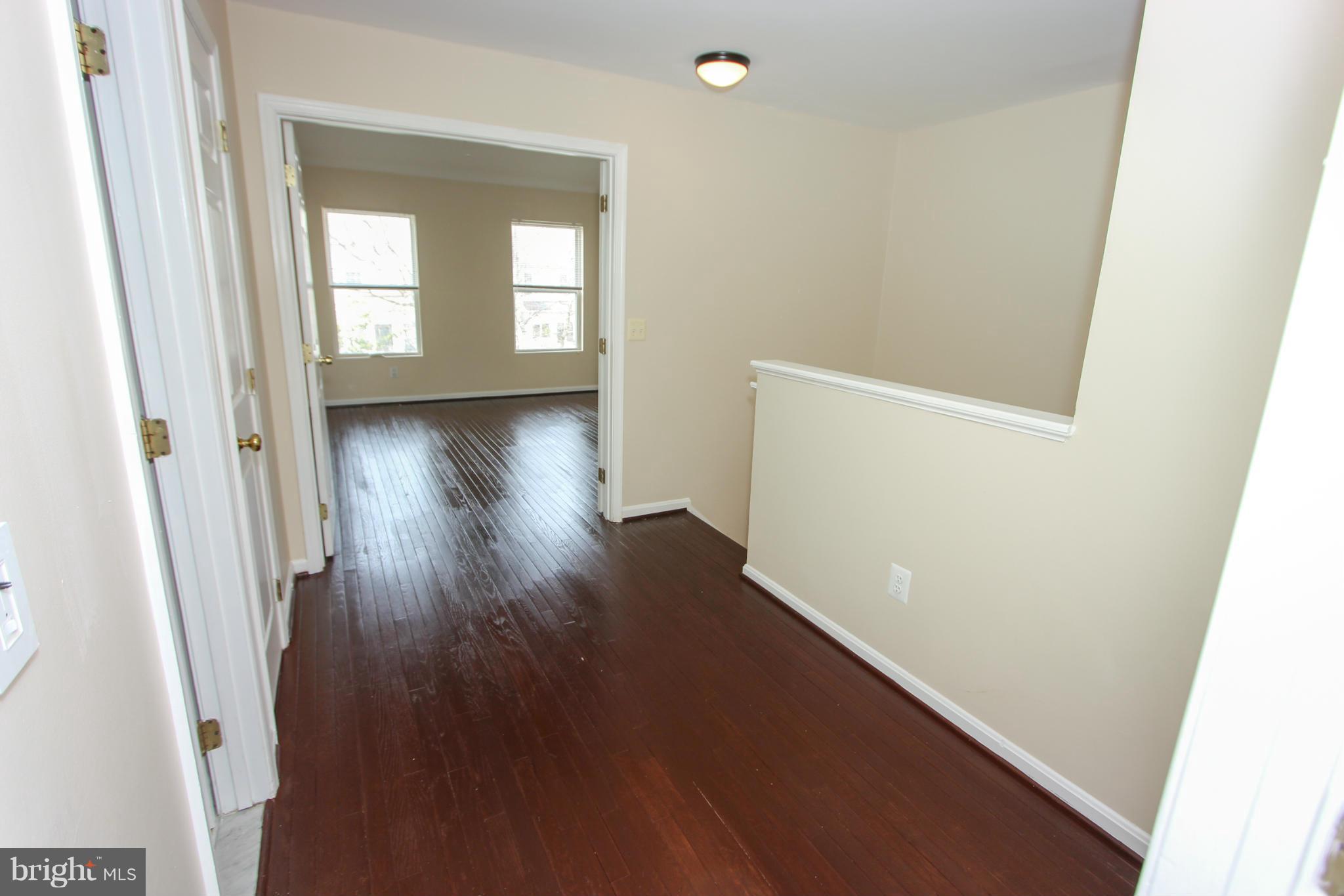 1706 Random Stone Court Reston, VA 20190 - Photo 18 of 30 view of an empty room with wooden floor and a window