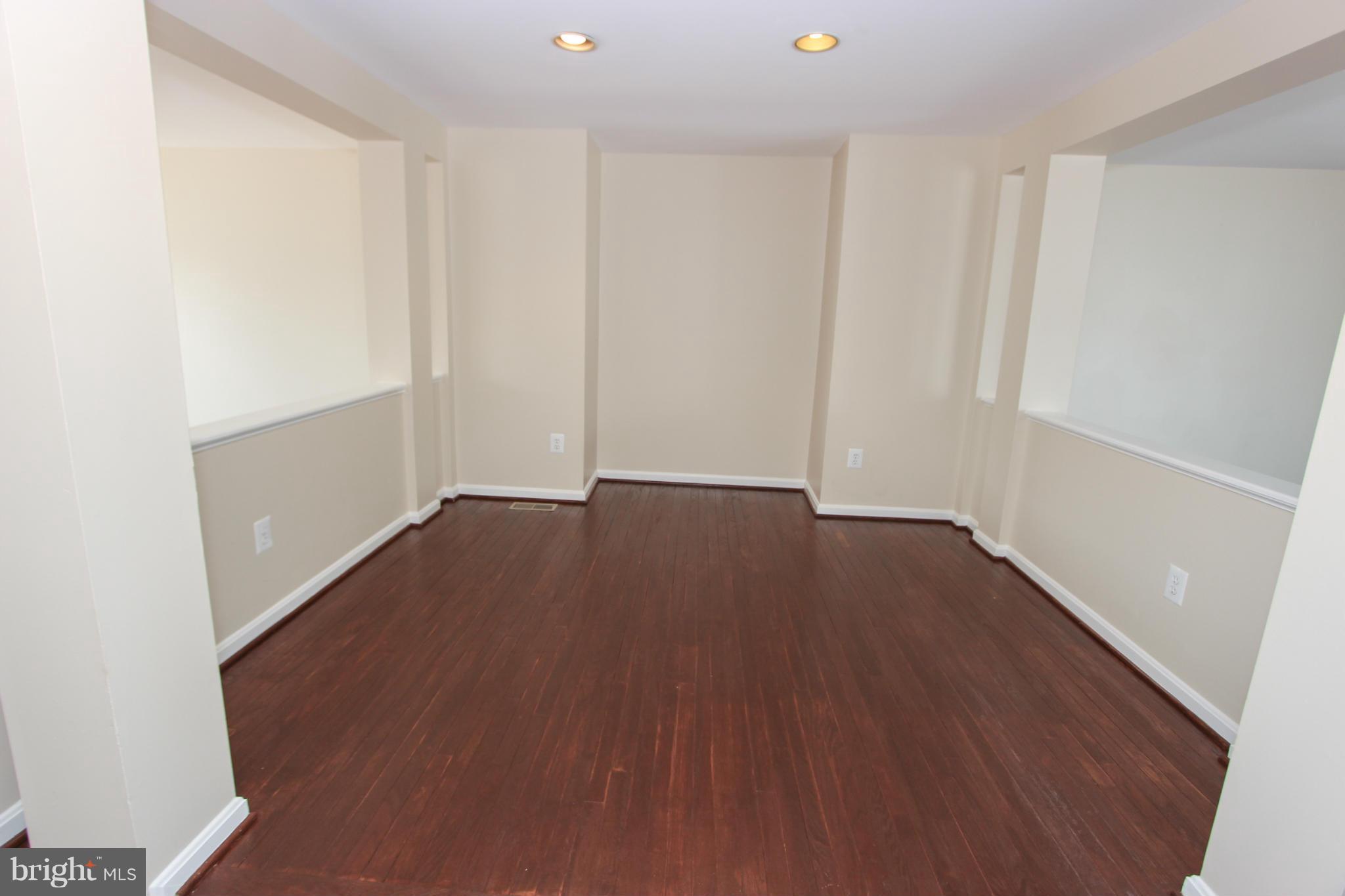 1706 Random Stone Court Reston, VA 20190 - Photo 19 of 30 an empty room with wooden floor and windows