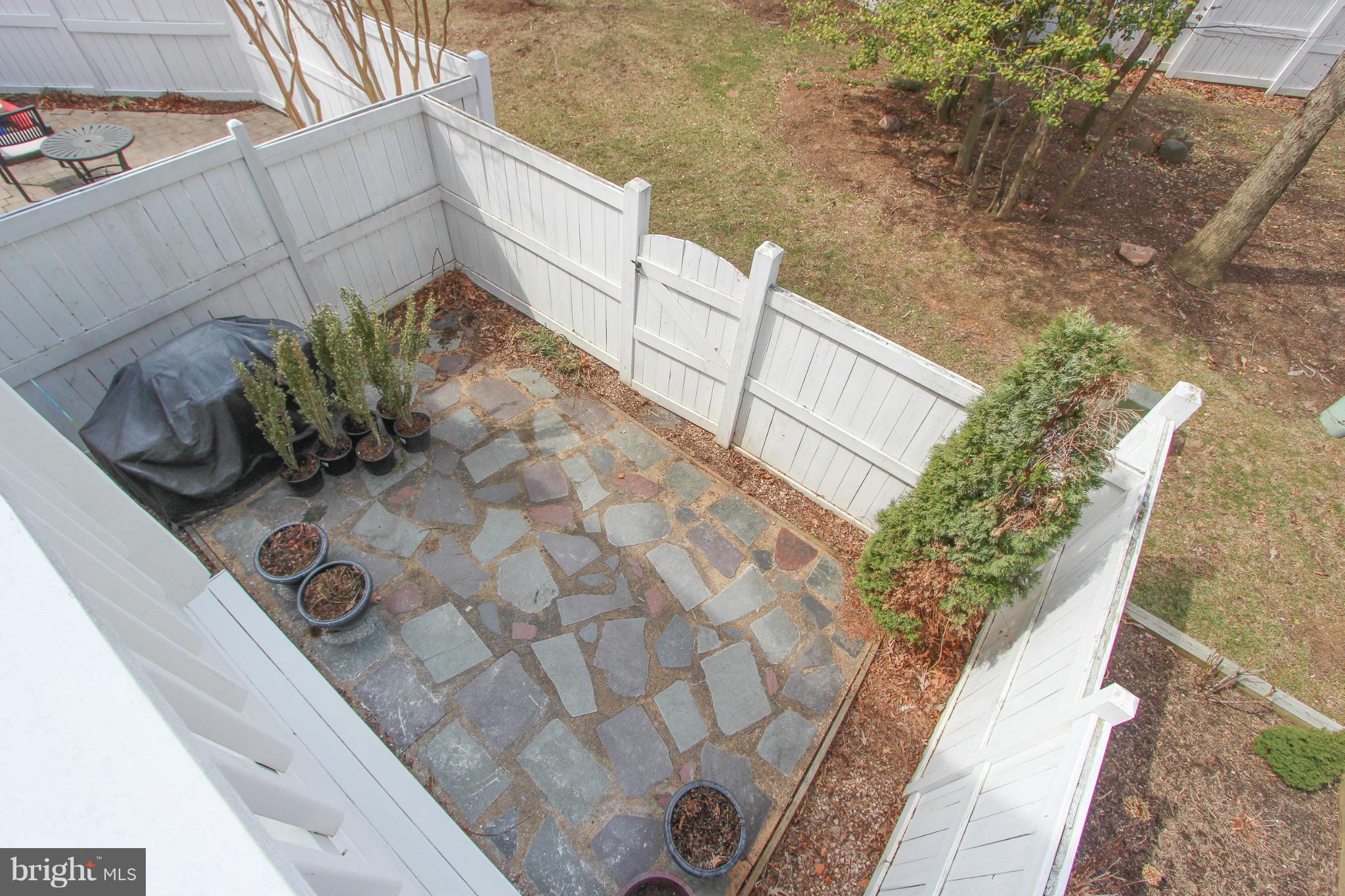 1706 Random Stone Court Reston, VA 20190 - Photo 3 of 30 a view of a flower garden with wooden fence