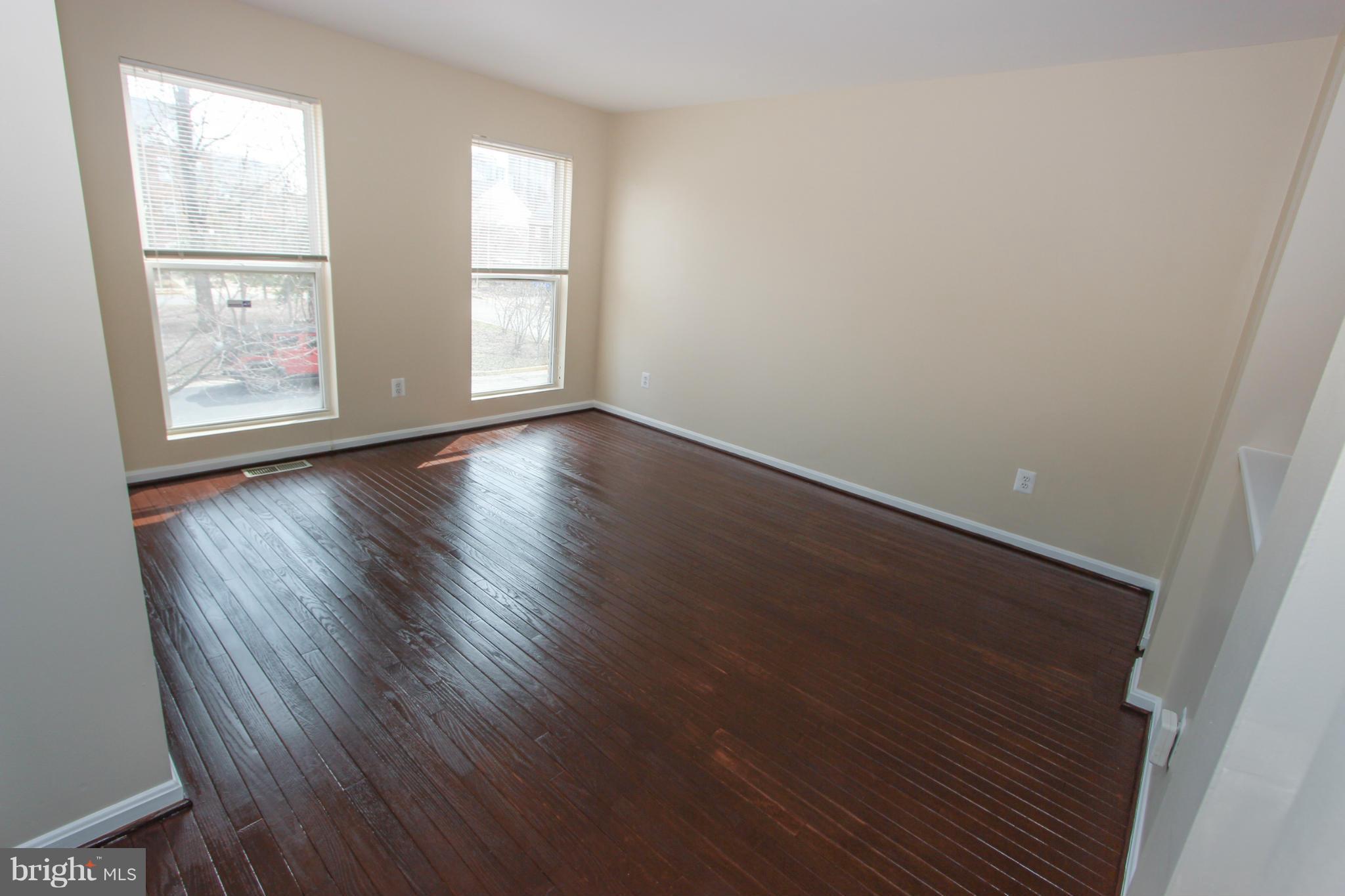 1706 Random Stone Court Reston, VA 20190 - Photo 21 of 30 an empty room with wooden floor and windows