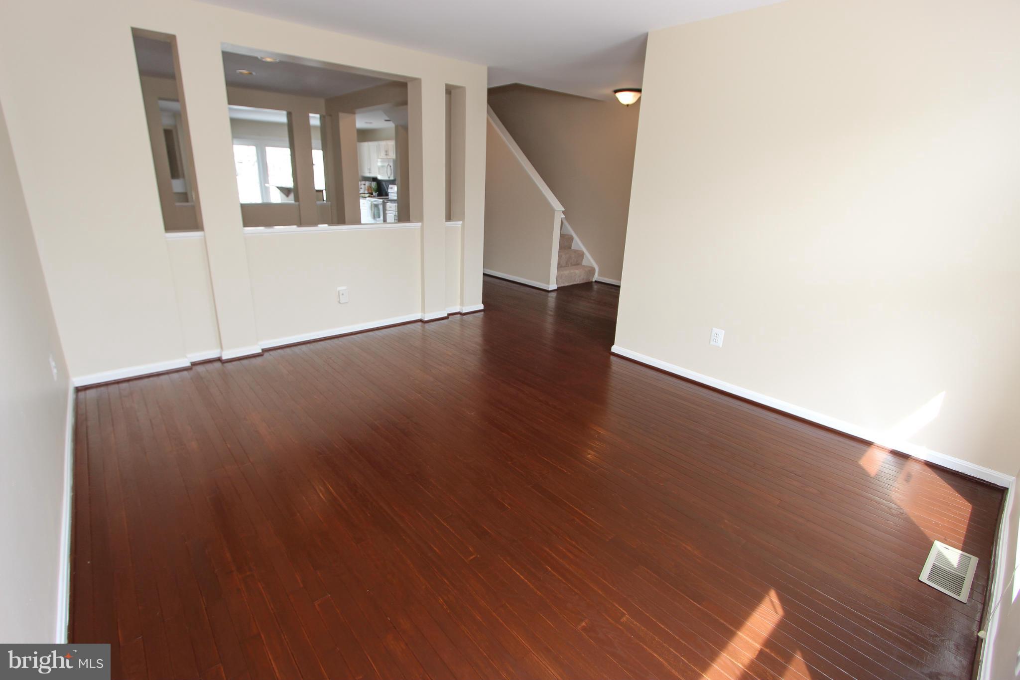1706 Random Stone Court Reston, VA 20190 - Photo 22 of 30 an empty room with wooden floor and windows